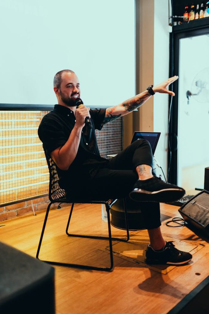 A speaker dynamically engaging the audience during an indoor event, emphasizing interaction and discussion.